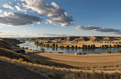 Great Falls Montana with Missouri River surrounded by wheat fields and cattle ranches under dramatic Big Sky clouds