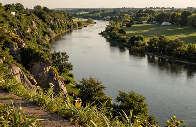 Peoria Illinois riverfront with Illinois River and green bluffs surrounded by farmland in warm golden light