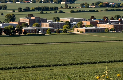 Champaign-Urbana Illinois where university campus meets vast flat soybean fields under late afternoon light