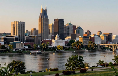 Nashville Tennessee skyline at golden hour with Cumberland River and green farmland on the outskirts