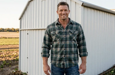 Travis, 40, North Carolina hog farmer from Duplin County smiling beside his barn on Yougotmatched