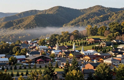 Asheville North Carolina with Blue Ridge Mountains, green mountain pastures, and Christmas tree farms on hillsides