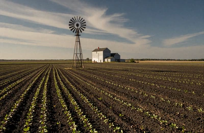 Illinois prairie farmland with rich black soil and a grain elevator on the horizon near the Wisconsin border